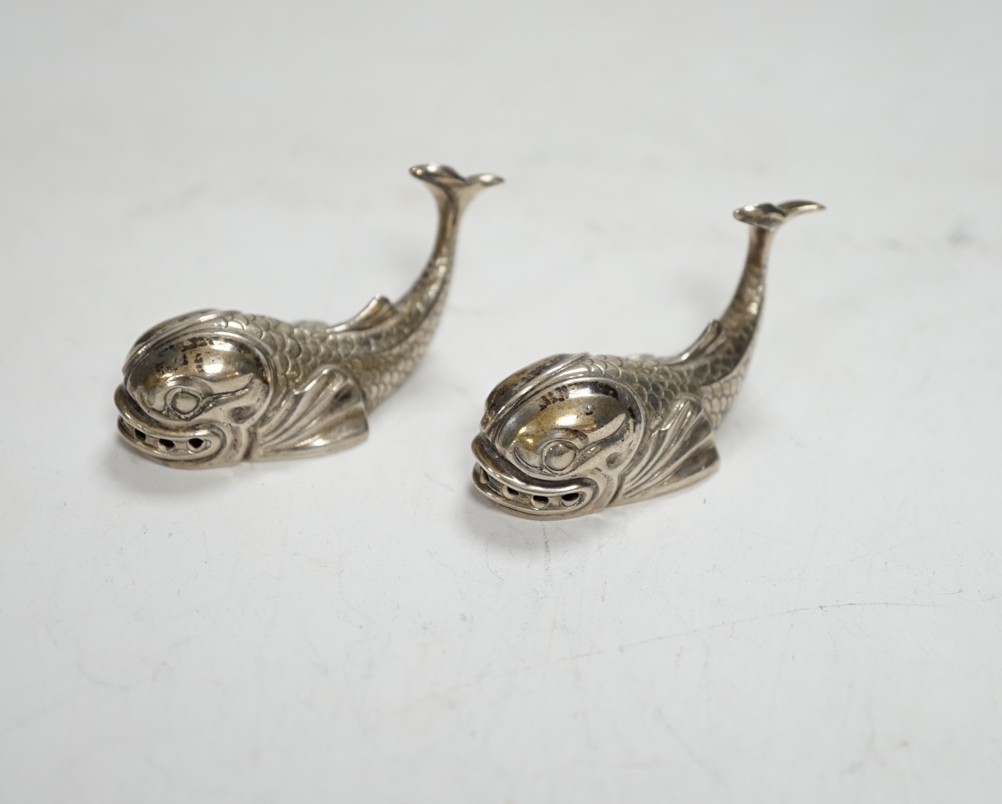 A pair of 20th century Italian Missiaglia 800 standard white metal novelty pepperettes, modelled as fish, length 42mm.